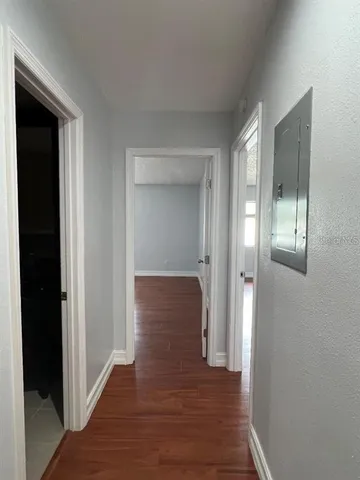 a view of a hallway with wooden floor