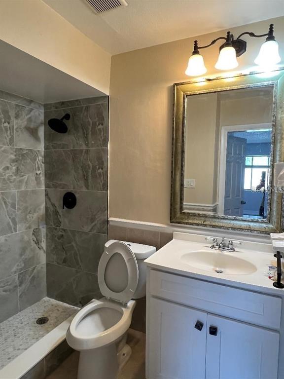 157 Springwood Circle, Unit C Longwood, FL 32750 - Photo 15 of 26 a bathroom with a sink a toilet and shower