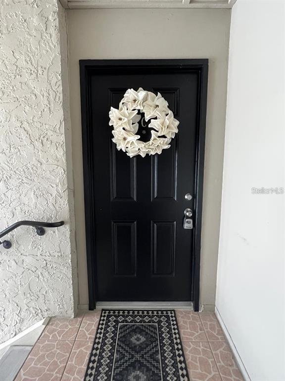 157 Springwood Circle, Unit C Longwood, FL 32750 - Photo 2 of 26 a view of a hallway with wooden floor and a potted plant