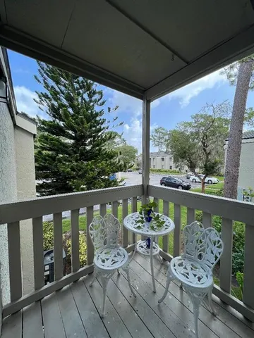 a view of a balcony with chairs and a table