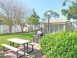 a view of a chair and table in backyard of the house