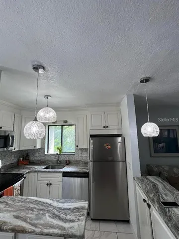 a kitchen with a stove and a refrigerator