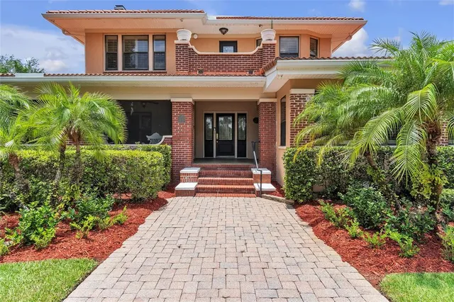 front view of a brick house with a large window