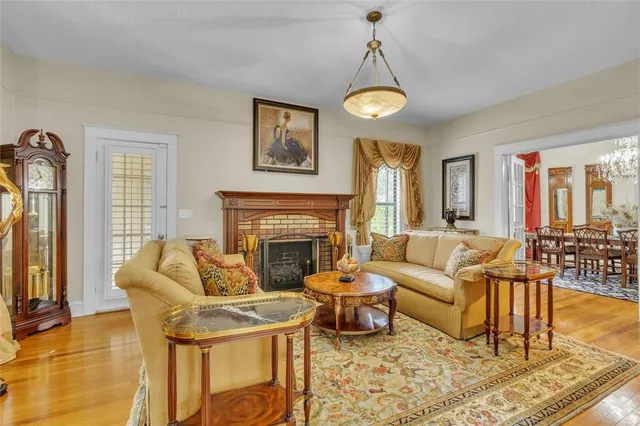 a work room with furniture a rug and a window