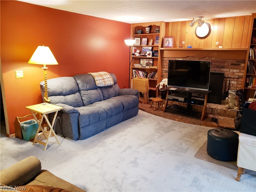 8644 Root Road North Ridgeville, OH 44039 - Photo 14 of 32 Carpeted living room with a fireplace
