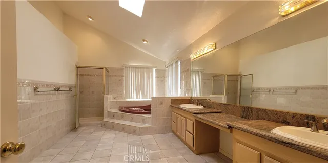 an empty room with windows and chandelier fan