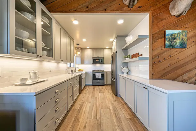 a large kitchen with stainless steel appliances kitchen island granite countertop a large counter top a sink stainless steel appliances and cabinets