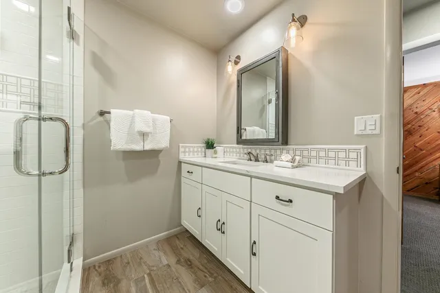 a bathroom with a toilet a sink and shower