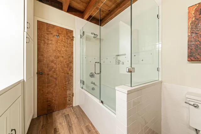 a view of a room with wooden floor and furniture
