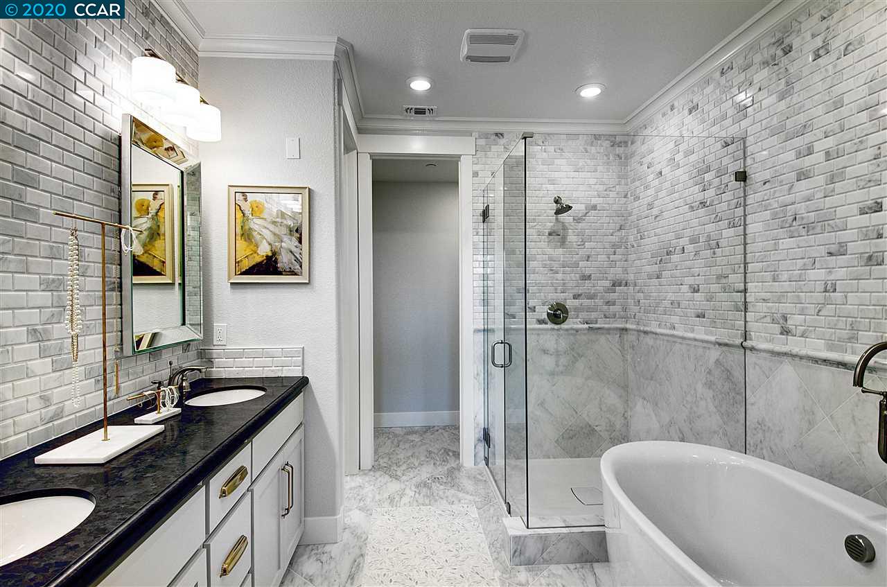 6787 Skyview Drive Oakland, CA 94605 - Photo 1 of 1 a bathroom with a granite countertop sink mirror bathtub and shower