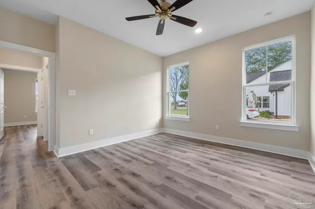 wooden floor in an empty room with a window