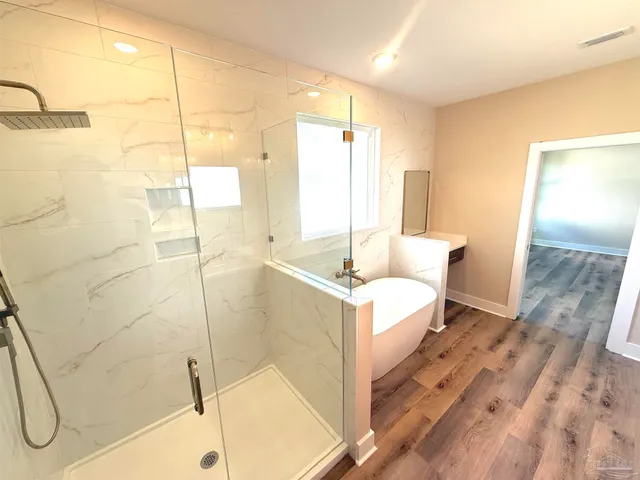 a bathroom with a bathtub and a shower