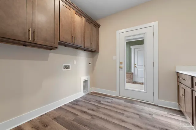 a view of empty room with wooden floor and cabinet
