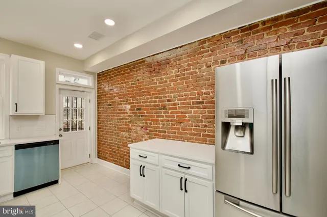 a kitchen with stainless steel appliances granite countertop a refrigerator and a stove