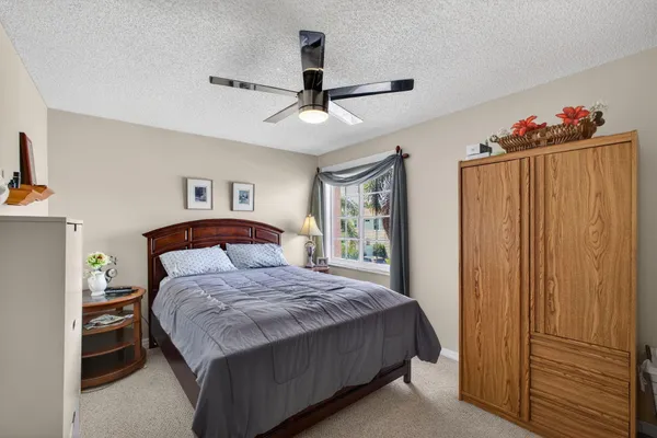 a bedroom with two beds and a large window