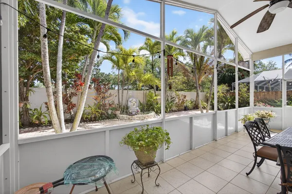 a view of a house with swimming pool and sitting area