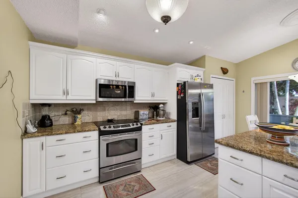 a kitchen with counter top space and a chandelier