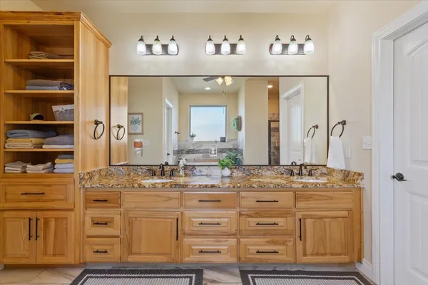 a bathroom with cabinets appliances and a mirror