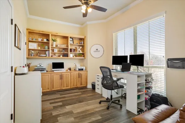 a view of a workspace with furniture and a flat screen tv