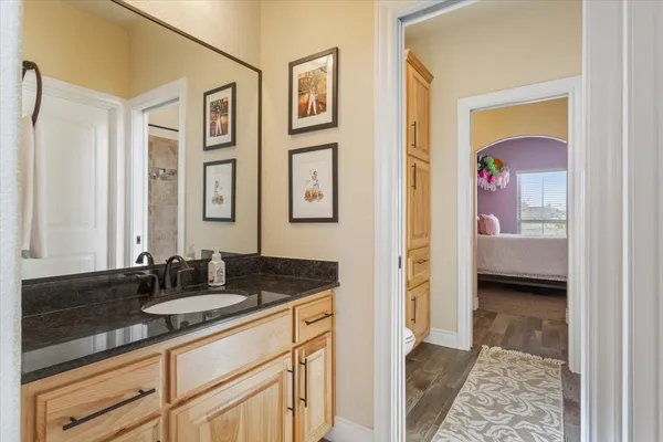 a en suite bathroom with a double vanity sink and a mirror