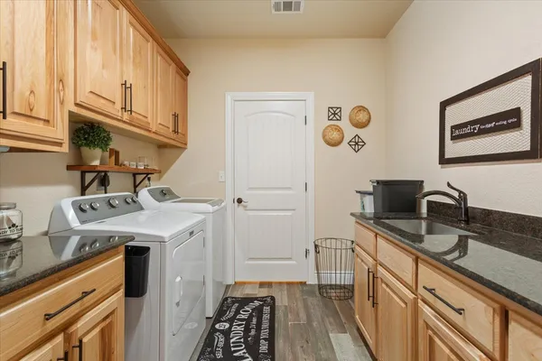 a kitchen with a sink a stove and cabinets
