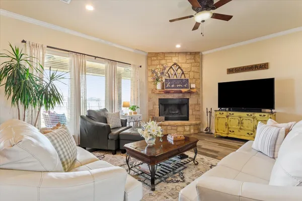 a living room with furniture a flat screen tv and a fireplace