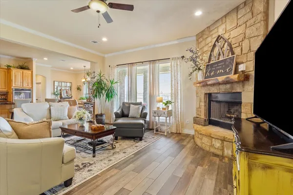 a living room with furniture a fireplace and a flat screen tv