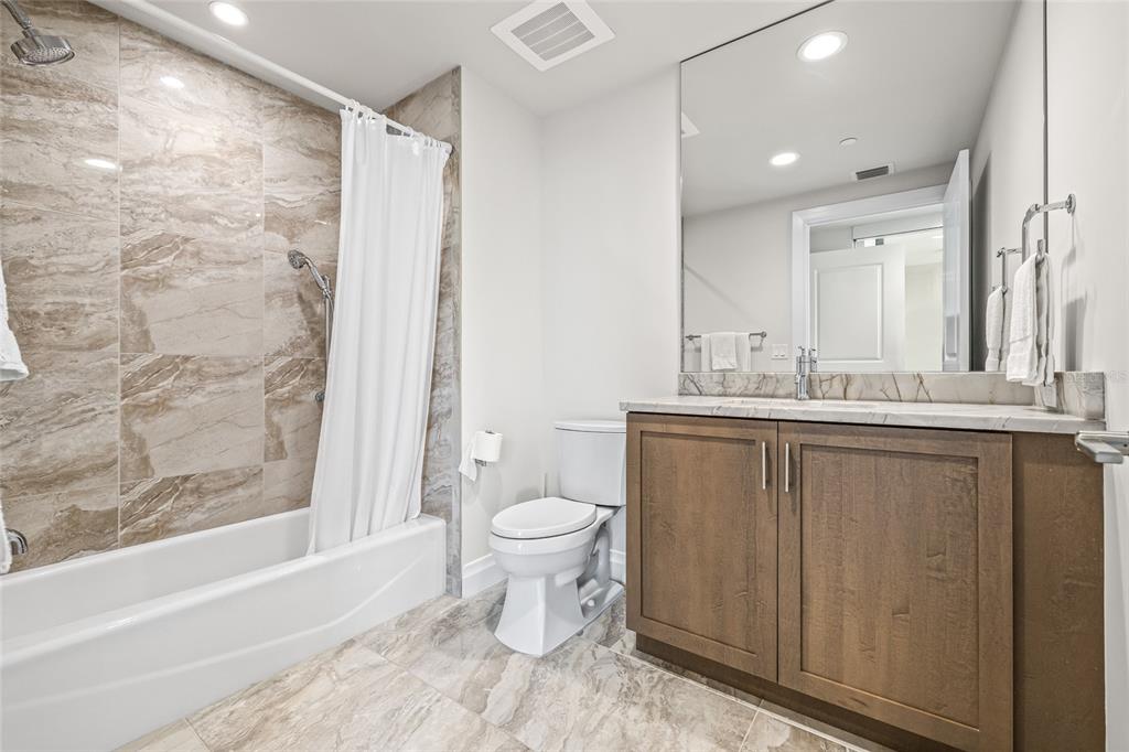 795 Collany Road, Unit 205 St. Petersburg, FL 33715 - Photo 26 of 67 a bathroom with a sink toilet and shower