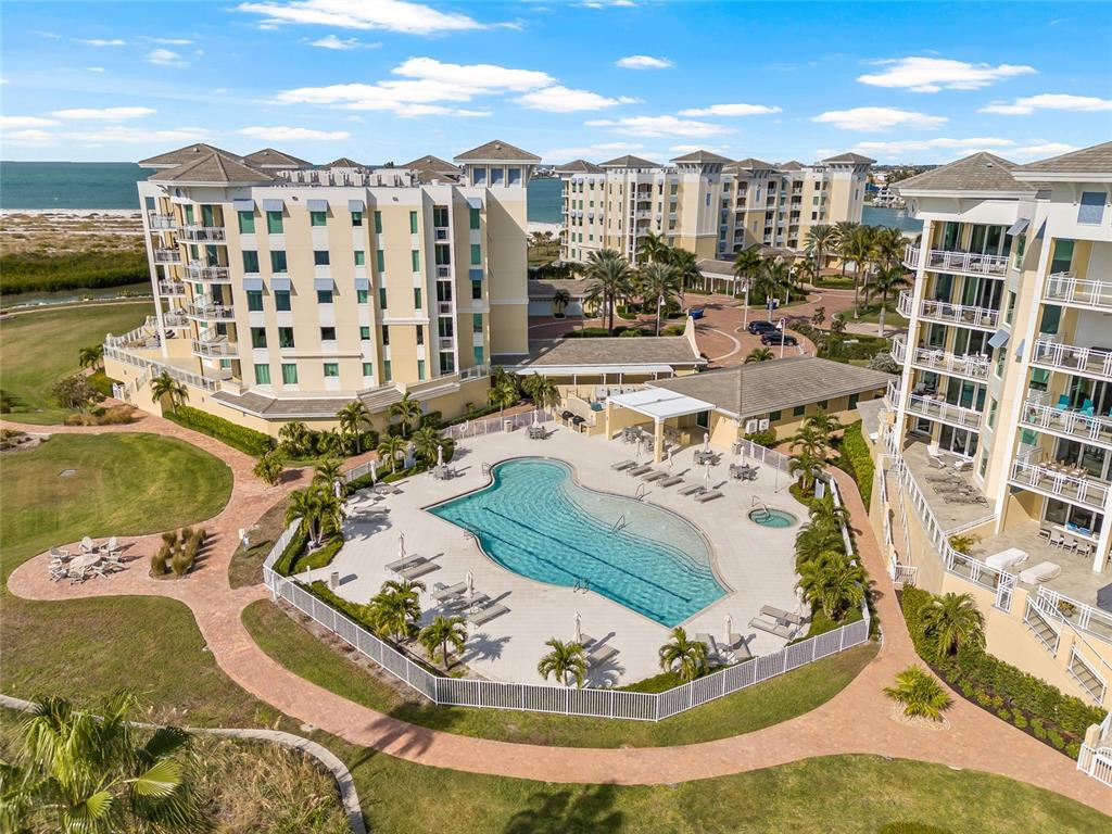 795 Collany Road, Unit 205 St. Petersburg, FL 33715 - Photo 3 of 67 a view of a swimming pool with a lawn chairs and entryway