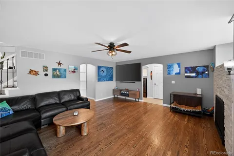 a living room with furniture and a wooden floor