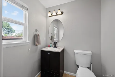 a bathroom with a toilet a sink and a mirror