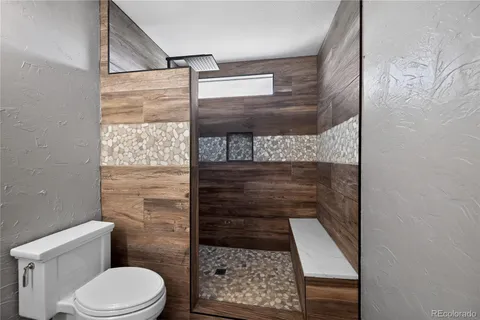 a bathroom with a toilet and a shower