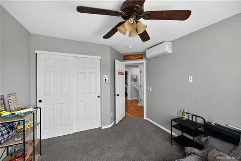 a view of a livingroom with a furniture and chandelier fan