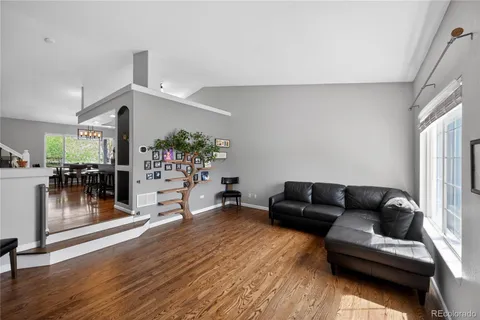 a living room with furniture and wooden floor