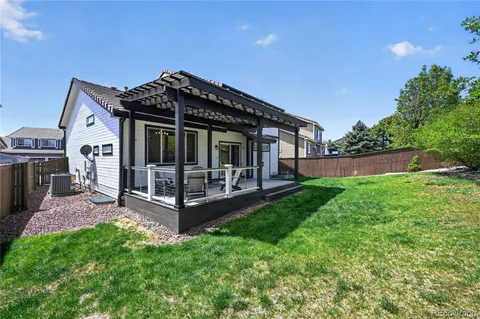 a view of a house with backyard and porch