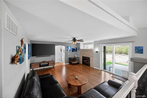 a living room with furniture a fireplace and a flat screen tv