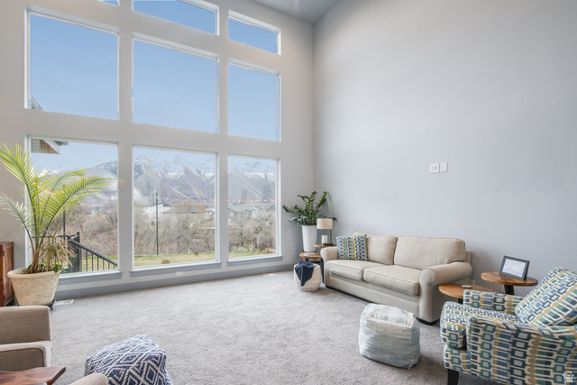 262 North Santa Fe Drive Mapleton, UT 84664 - Photo 4 of 46 Vaulted ceiling great room with expansive window wall, light gray wall finishes, and gray carpeting