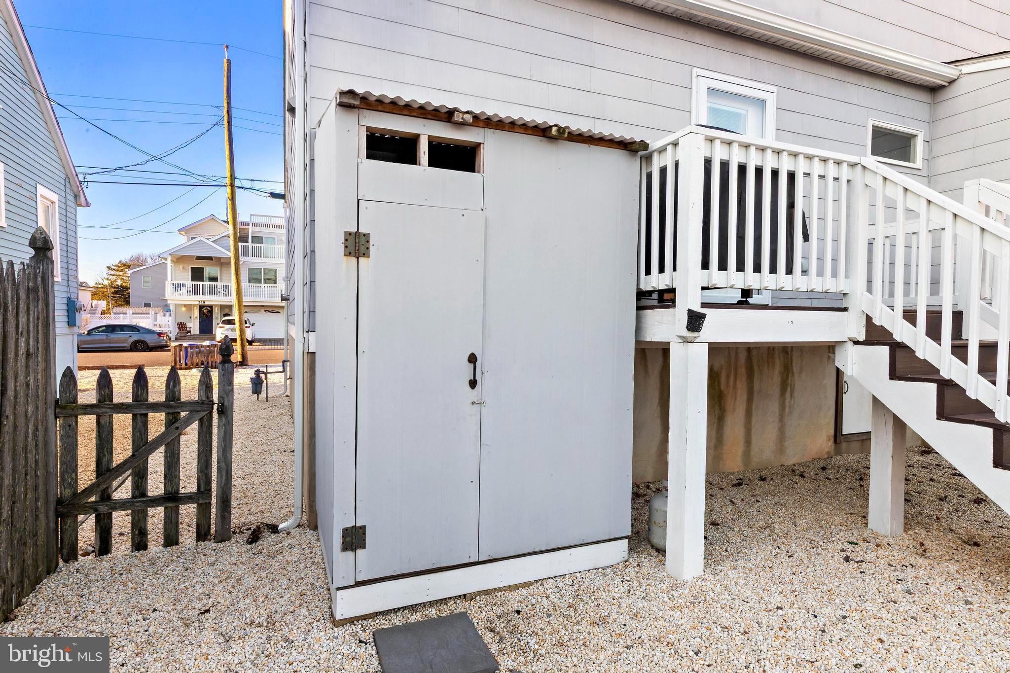 213 West 13th Street Ship Bottom, NJ 08008 - Photo 12 of 70 a view of a porch with a table and chairs