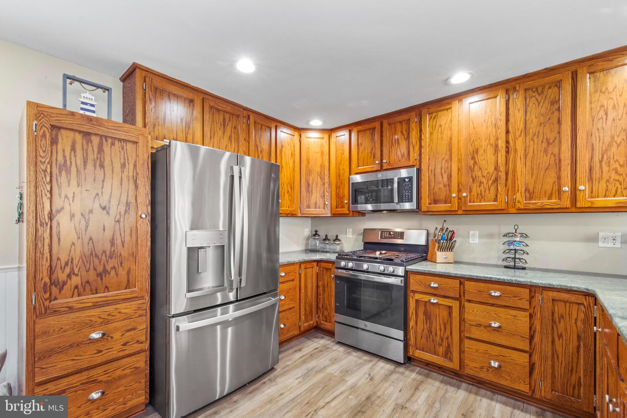 213 West 13th Street Ship Bottom, NJ 08008 - Photo 25 of 70 a kitchen with stainless steel appliances granite countertop a refrigerator stove and sink