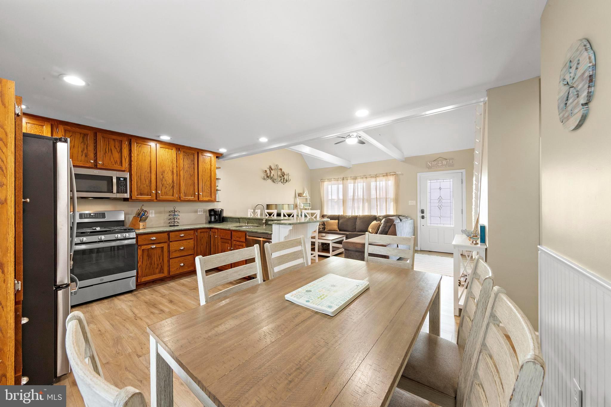 213 West 13th Street Ship Bottom, NJ 08008 - Photo 35 of 70 a kitchen with stainless steel appliances kitchen island granite countertop a stove and white cabinets