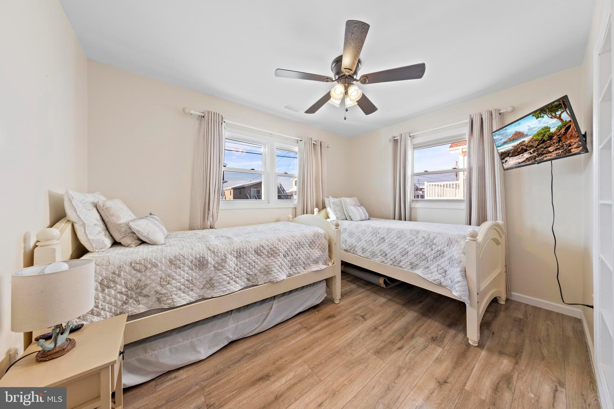 213 West 13th Street Ship Bottom, NJ 08008 - Photo 39 of 70 a bedroom with a bed and wooden floor