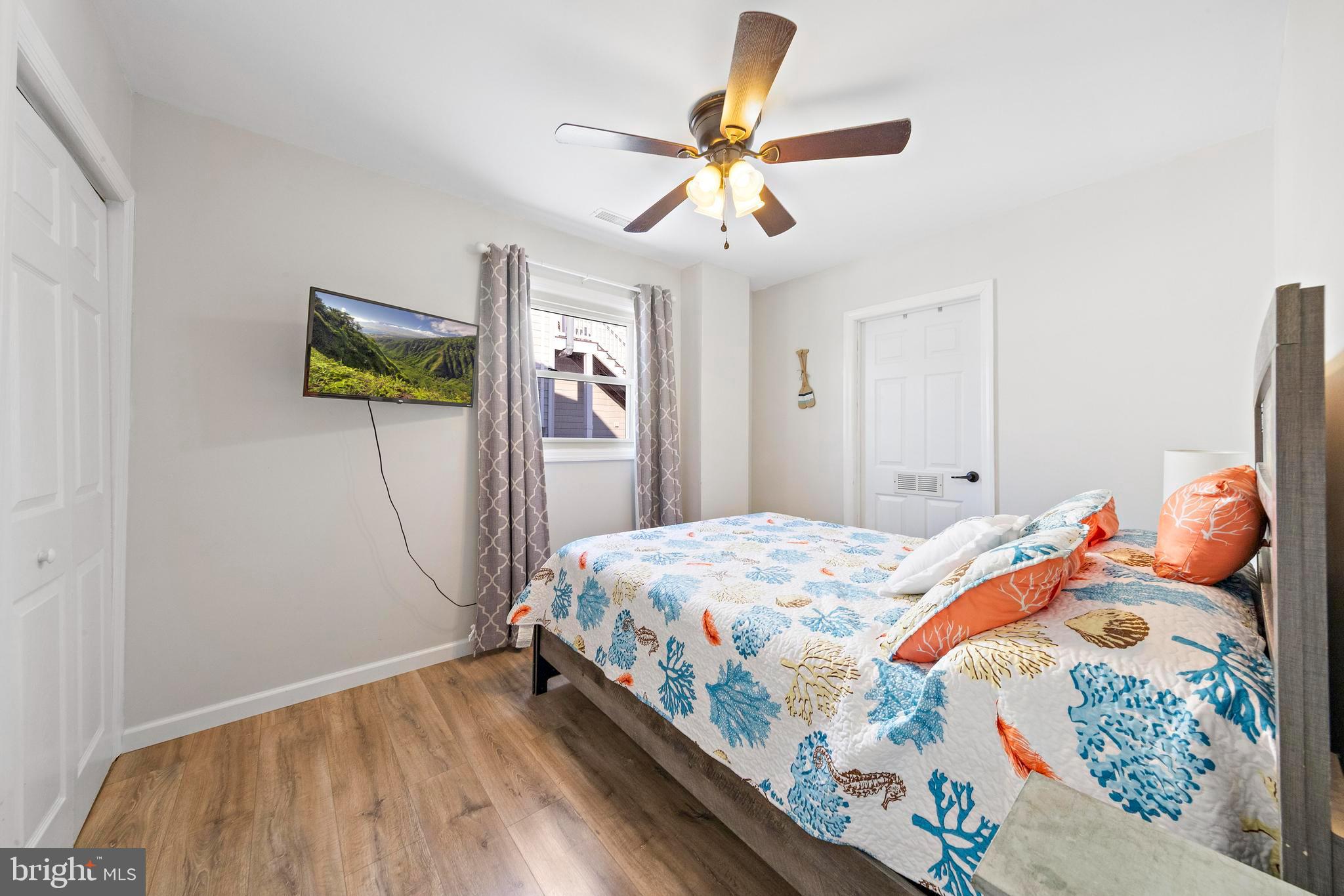 213 West 13th Street Ship Bottom, NJ 08008 - Photo 40 of 70 a bedroom with a bed and a chandelier