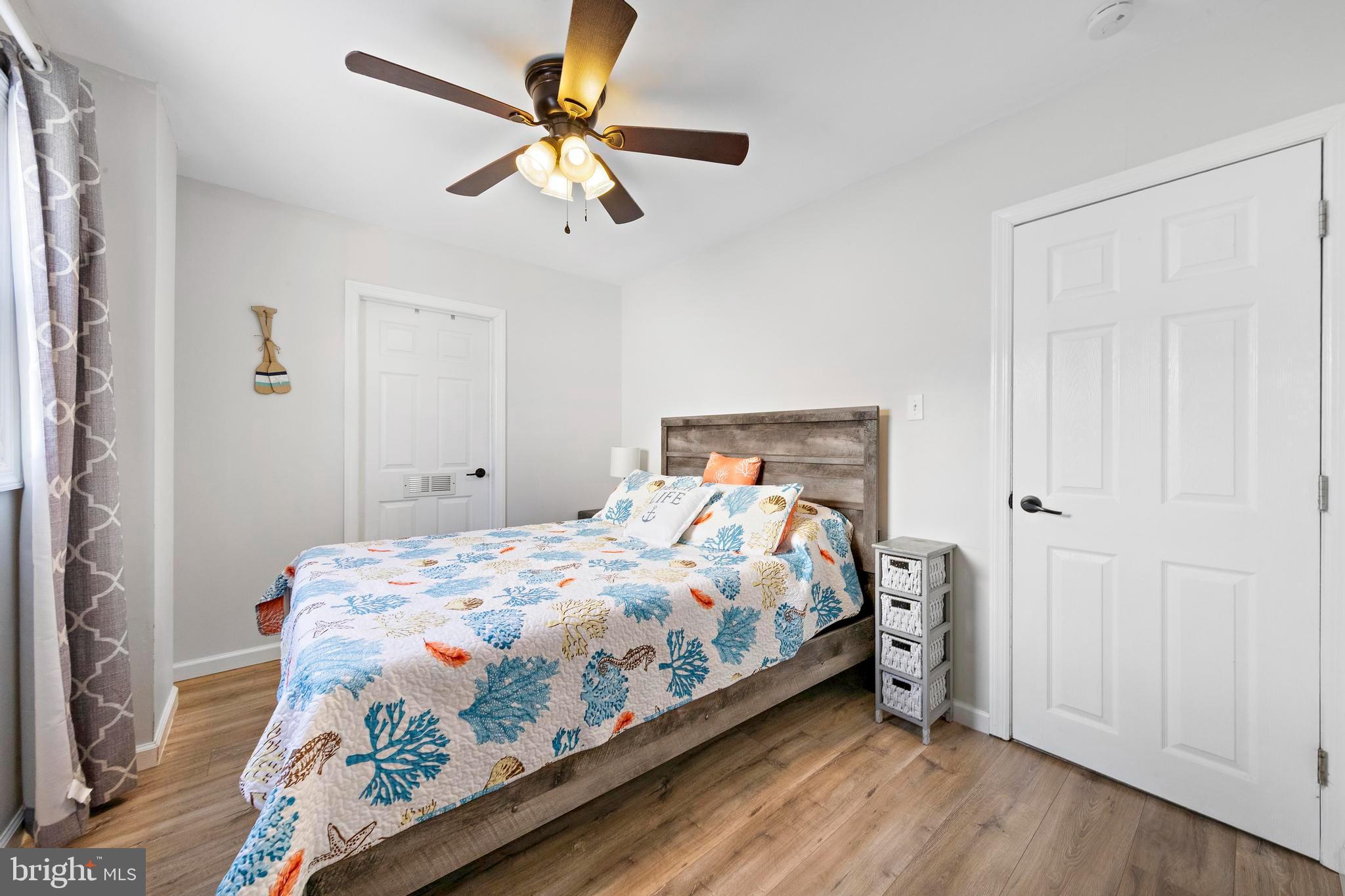 213 West 13th Street Ship Bottom, NJ 08008 - Photo 41 of 70 a bedroom with a bed and a chandelier