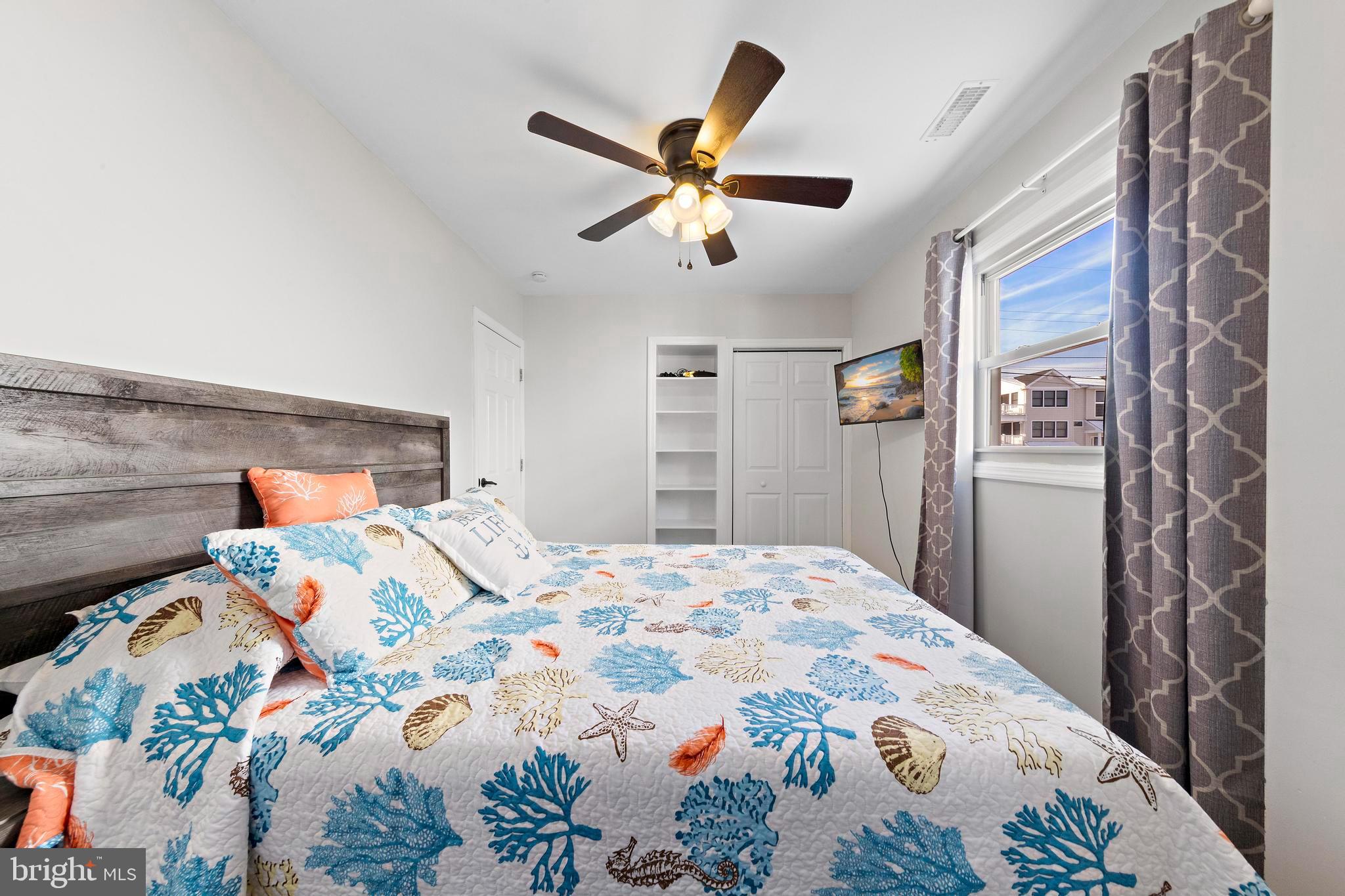 213 West 13th Street Ship Bottom, NJ 08008 - Photo 42 of 70 a bedroom with a bed and a chandelier