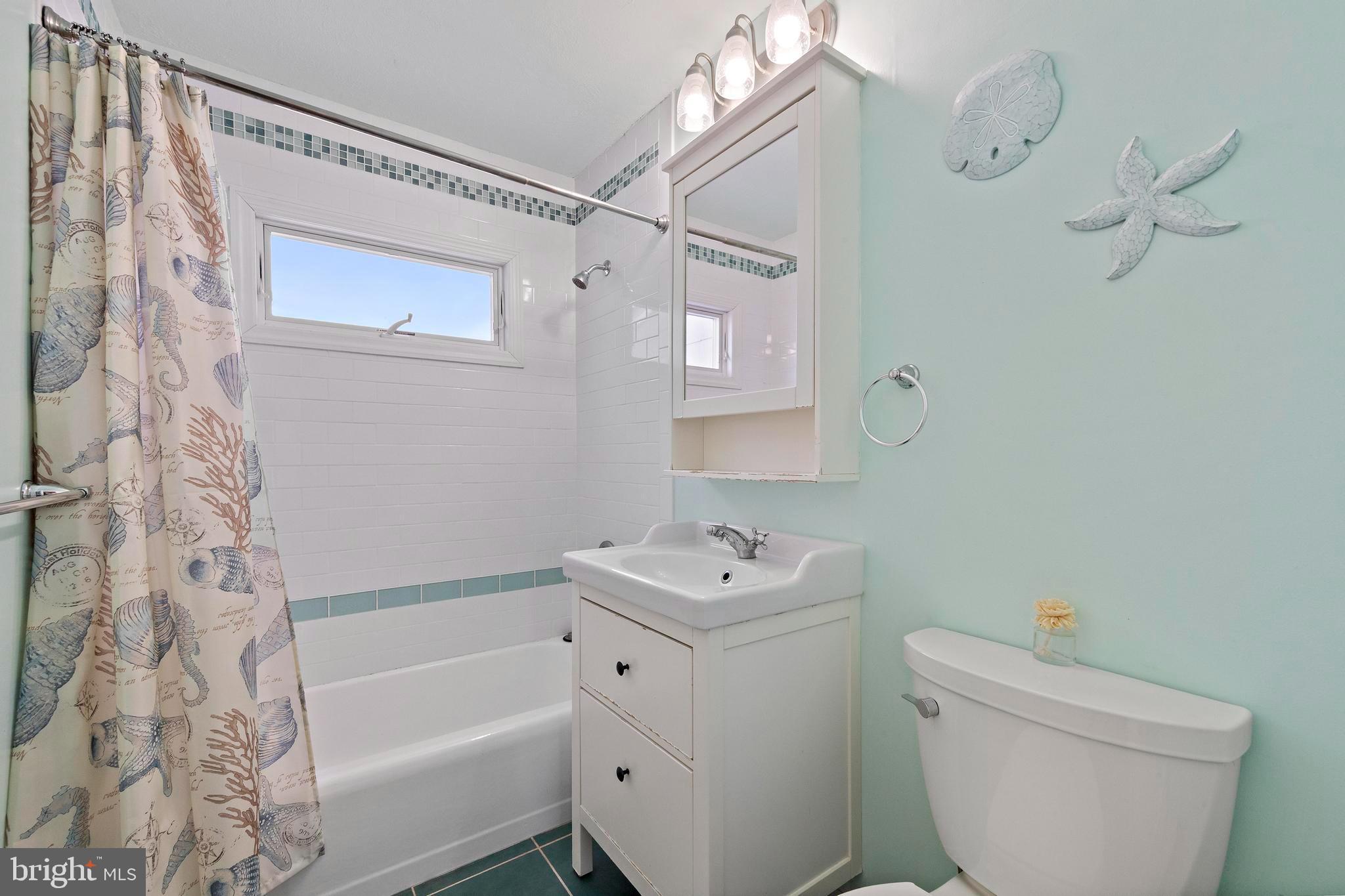 213 West 13th Street Ship Bottom, NJ 08008 - Photo 43 of 70 a bathroom with a sink a toilet and shower