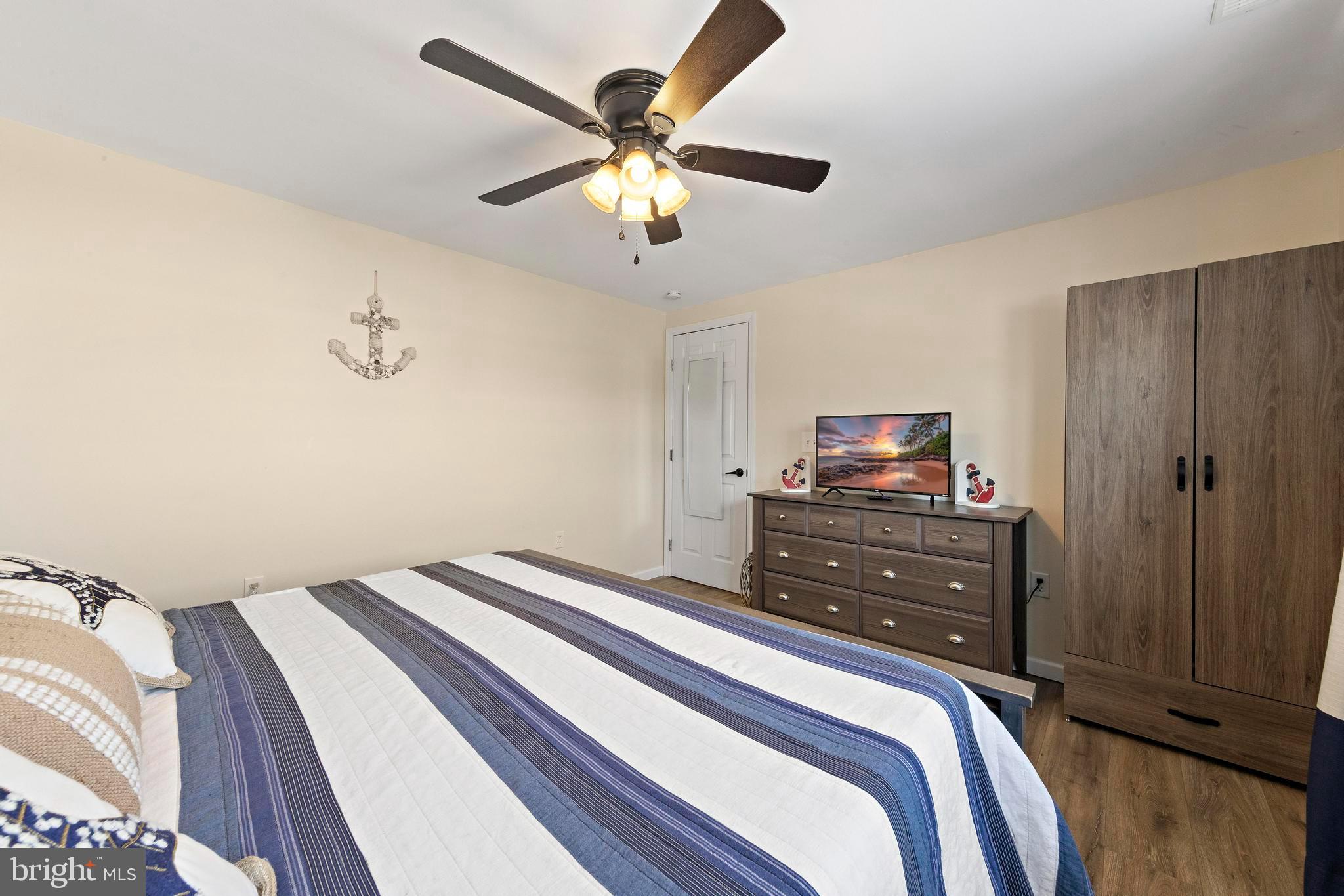 213 West 13th Street Ship Bottom, NJ 08008 - Photo 45 of 70 a bedroom with a bed and a tv