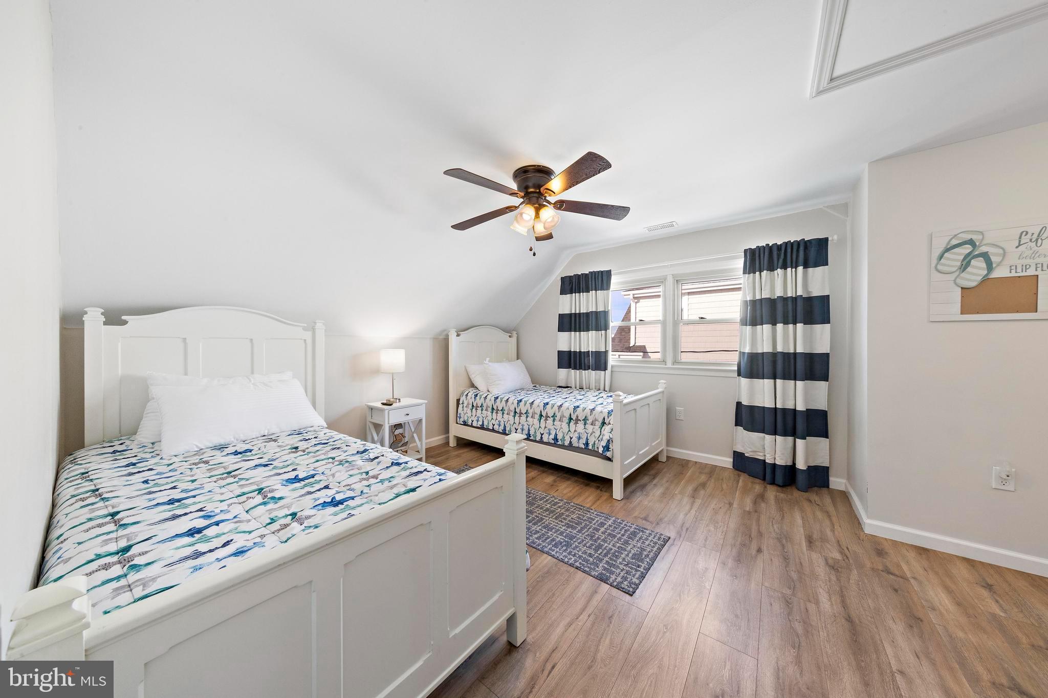 213 West 13th Street Ship Bottom, NJ 08008 - Photo 48 of 70 a bedroom with a bed and a book shelf