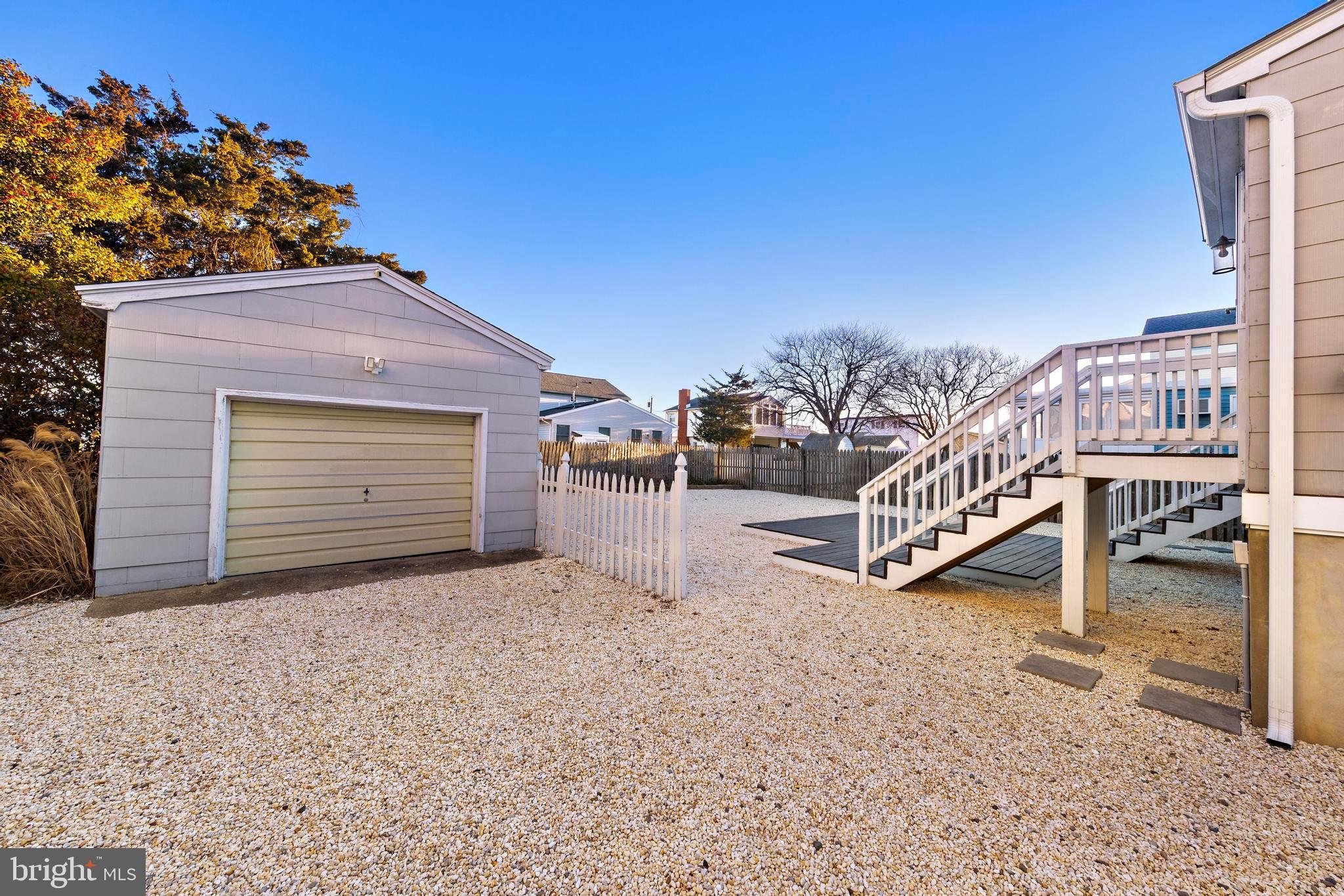 213 West 13th Street Ship Bottom, NJ 08008 - Photo 6 of 70 a view of a house with a yard and a garage