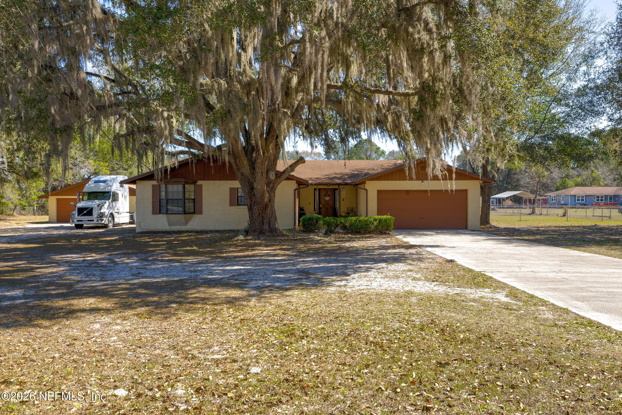 4065 Magill Road Jacksonville, FL 32220 - Photo 23 of 42 a front view of a house with a yard and large trees