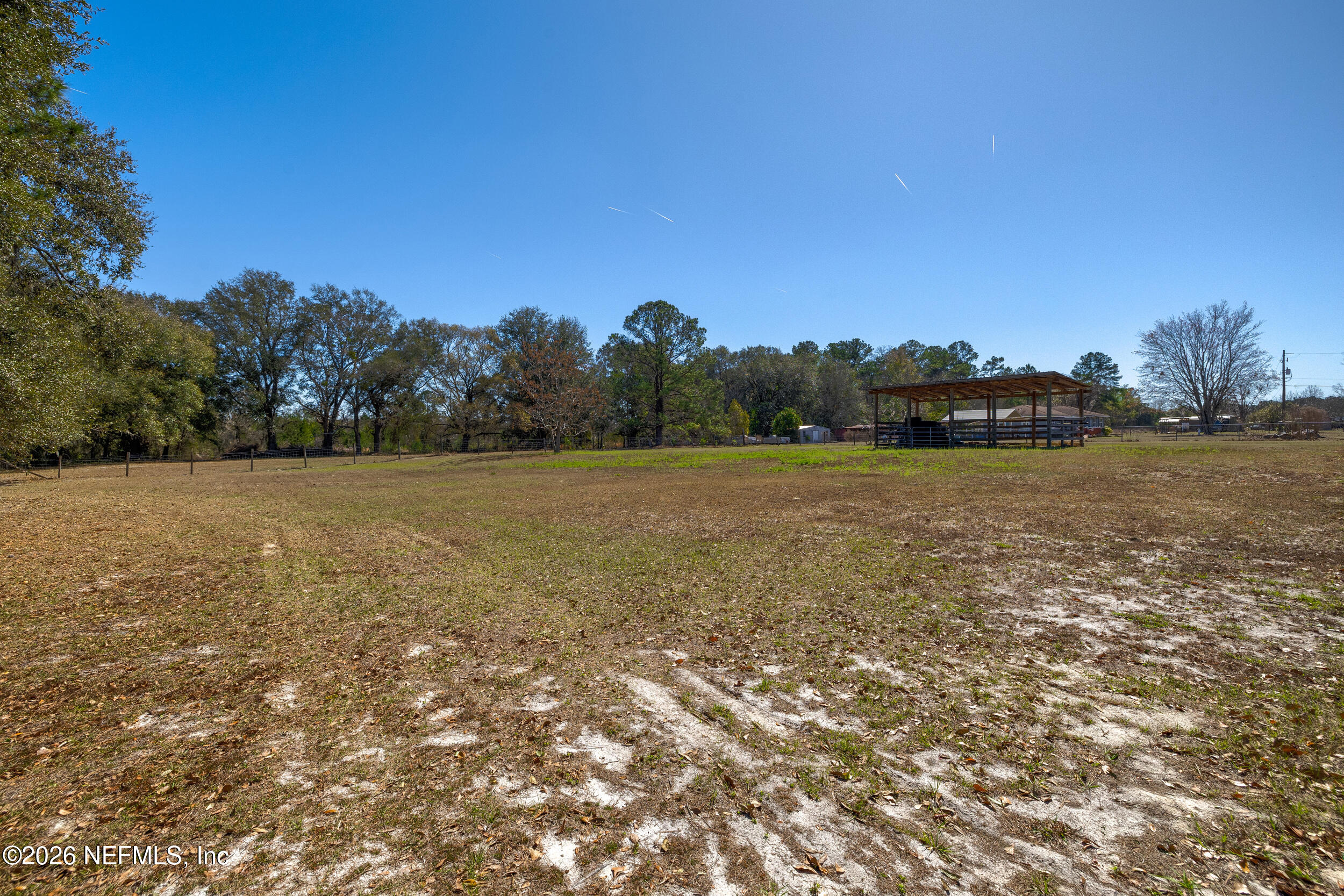 4065 Magill Road Jacksonville, FL 32220 - Photo 33 of 42 a view of a field with trees in the background